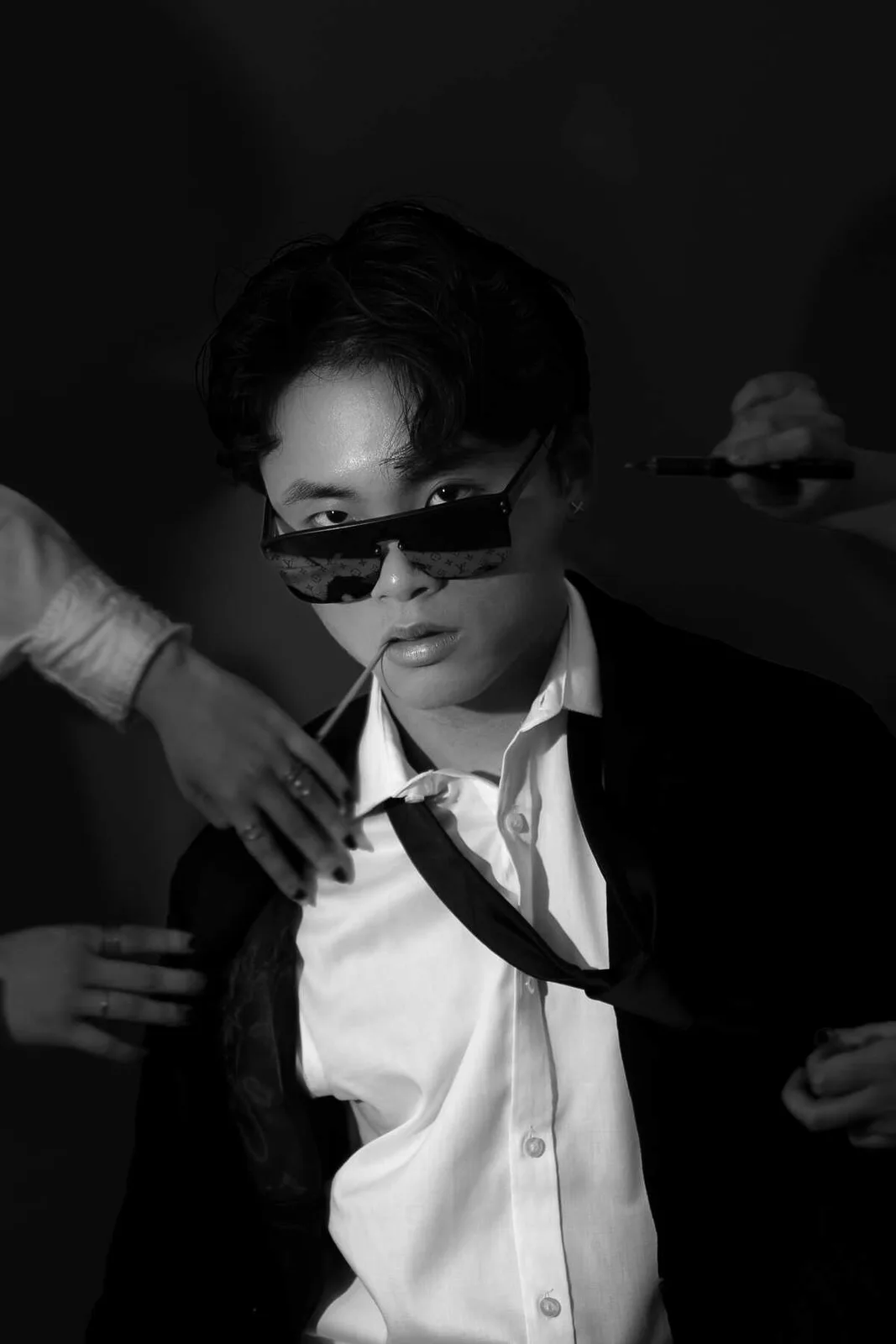 Zhixing Chen being fitted in a black suit before a show