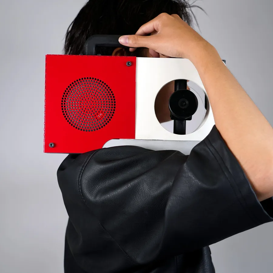 Z holding the Be the Beat boombox, a cylindrical AI-powered speaker