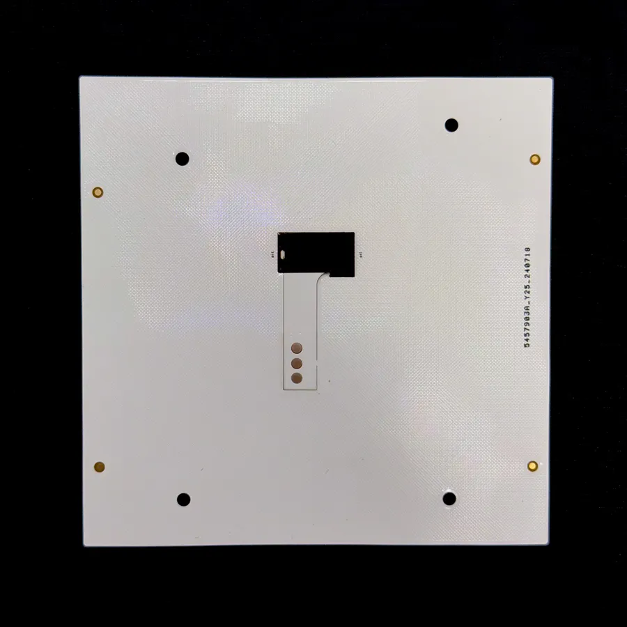 A flexible PCB panel on black, showing the stiffened strip with three solder pads