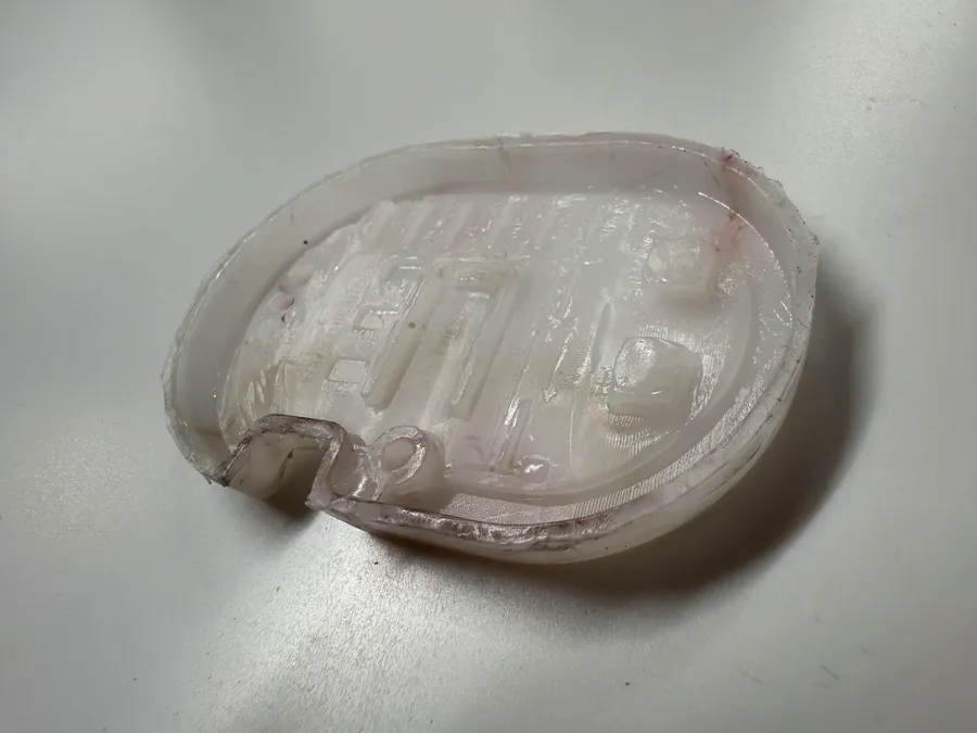 A white PP Gaugey piece from the other side, showing the undercut and coring
